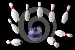 Bowling pins and ball isolated on black background photo