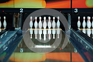 Bowling pins reflecting in bowling alley lane