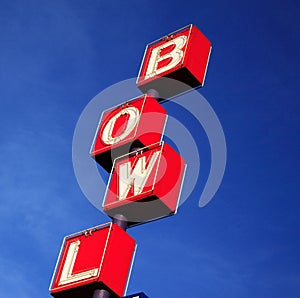 Bowling rink sign red blue sky