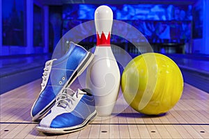 Bowling shoes and bowling ball on the game track close-up