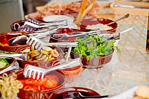 bowls with chopped vegetables and fruits on the table.