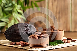 Bowls of cocoa beans and powder near pod