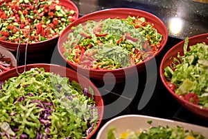 Bowls of colorful, leafy salads ready to serve. They mirror the shift towards plant-based diets and sustainable eating