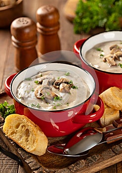 Bowls of creamy mushroom soup with sliced mushrooms and parsley