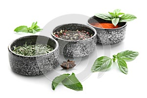 Bowls with different spices on white background