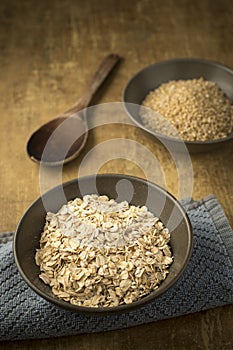 Bowls of dried steel cut and rolled oats photo