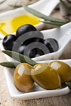 In the bowls extra virgin olive oil and organic olives