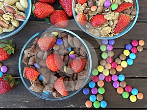 Bowls with Flakes,strawberries,peanuts and colored candy