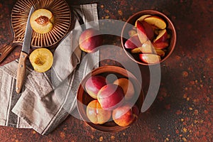 Bowls with fresh peaches on table