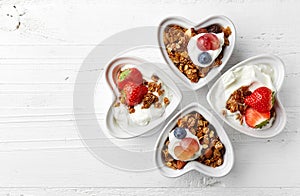 Bowls of granola, yogurt and berries