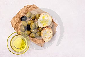 Bowls with Green and Black Olive Olive Oil Artisan Bread Mediterranean Food Light Gray Background Horizontal