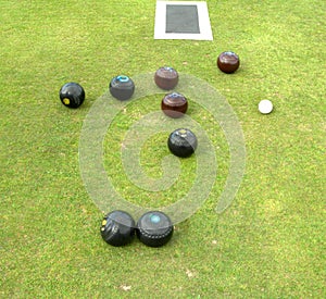 Bowls, jack, and mat lying on bowling green