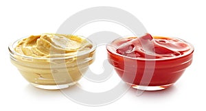 Bowls of mustard sauce and ketchup photo