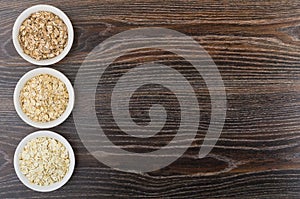 Bowls with oat, rye, barley flakes from left side table