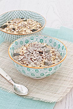 Bowls of oats with nuts and seeds