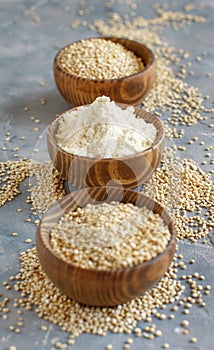 Bowls of raw white quinoa seeds and flour  close up