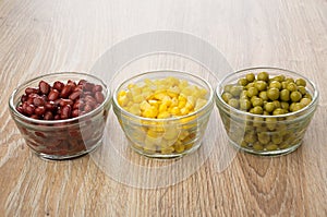 Bowls with red beans, sweet corn and green peas