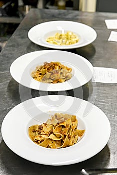 Bowls on a restaurant counter with tagliatelli