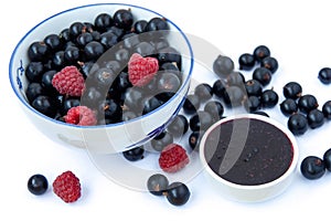 Bowls with seasonal berries, a mix of fresh berries isolated on white background, blueberries, currants, raspberries