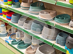 Bowls on shelves in pet shop. Market shelves with supplies and accessories dogs and cats