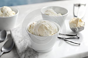 Bowls with tasty vanilla ice cream