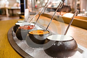 Bowls with various sauces at the self-service restaurant.