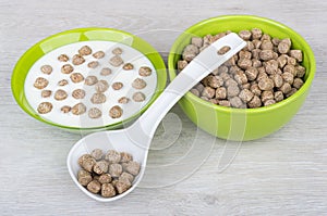 Bowls with yogurt and extruded rye bran, plastic spoon