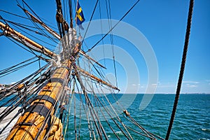 Bowspirit of old wooden sail ship with lots of rope gear