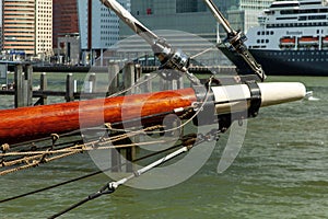 Bowsprit of a historic sailing ship with part of the Rotterdam buildings in the background
