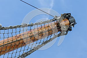 Bowsprit tree in front of a fishing boat with a hanging net