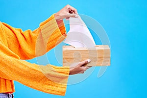 Box, blue background and hands of woman with tissues for flu, sickness and sinus mockup in studio. Healthcare