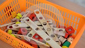 Box with children toys. Little boy puts a toy in the toy box, close-up