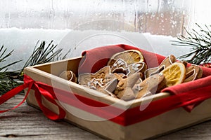 Box with Christmas ginger cookies by the window