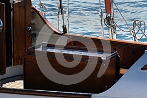 Box with cold food or champagne at the middle part of the wooden yacht or boat