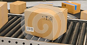 Box on conveyor roller. Warehouse or delivery concept image