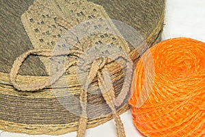 Box covered with fabric and a ball of orange yarn
