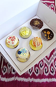 Box of cup cakes in take away carrying box