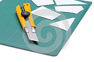 Box Cutter Knife just Cutting white paper on cutting mat