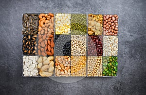 Box of different whole grains beans and legumes seeds lentils and nuts colorful snack background top view Collage various beans