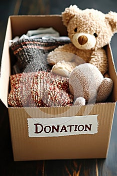 A box of donated items including a teddy bear and a football