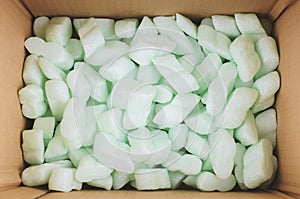 Box filled with polystyrene foam peanuts packaging filler cushioning material