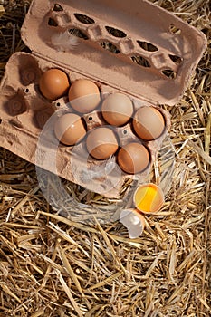 Box of fresh hens eggs on straw