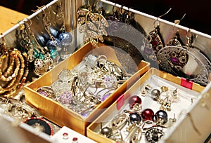 Box full of women's jewelry and earrings