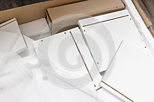 Box with furniture assembly parts on the floor