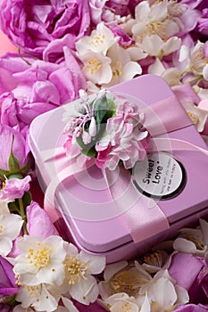 Box with gift  around roses  background. romantic and beauty concept