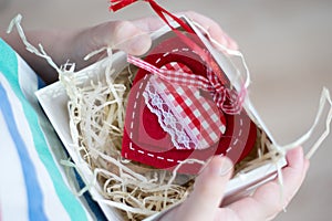 Box with a gift valentine heart a child& x27;s hand on Valentine& x27;s