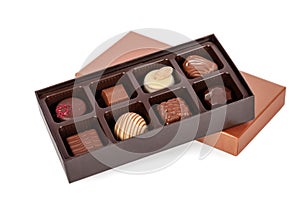 Box of gourmet bonbons, aka bon-bons and truffles isolated on white