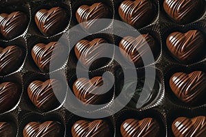 Box of heart-shaped chocolate, one candy empty