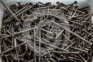 A box with a lot of old screws