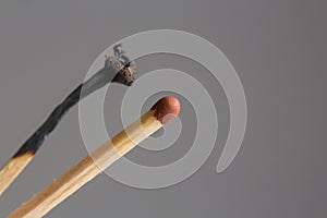 Box of matches on gray background.Matches in the hand.